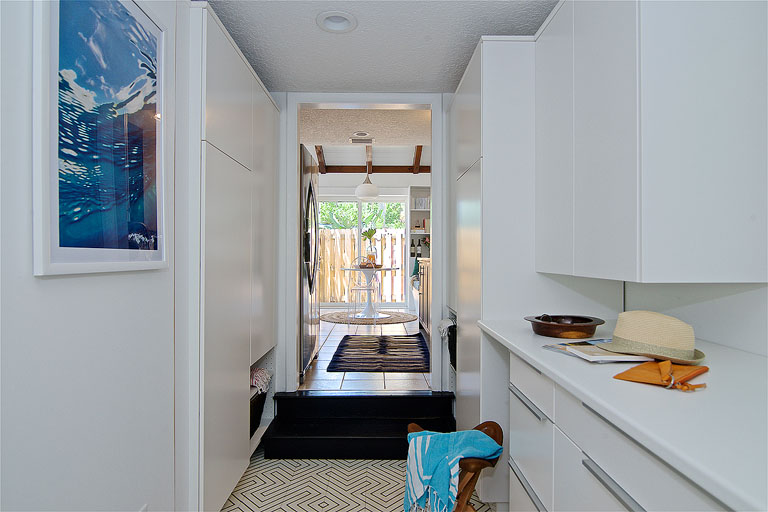 A clean modern white mud room / pantry combo by Denver based interior designer Fernway & Avalon.